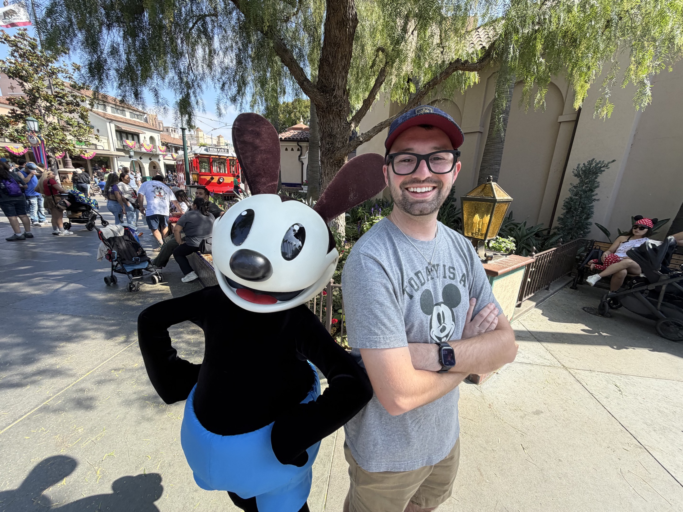 Cam posing with Oswald at Disneyland