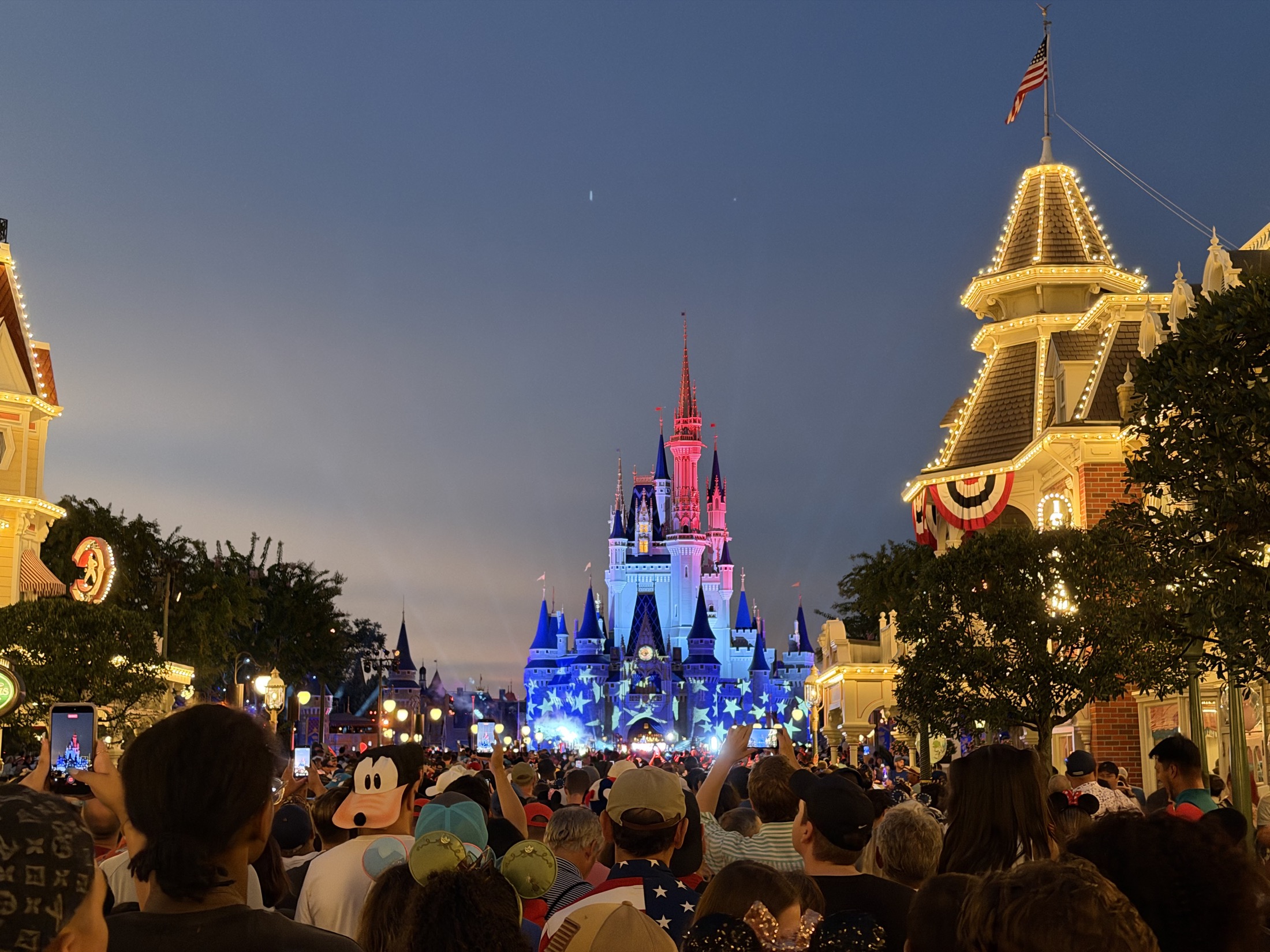 Cinderella Castle lit in red, white, and blue at night