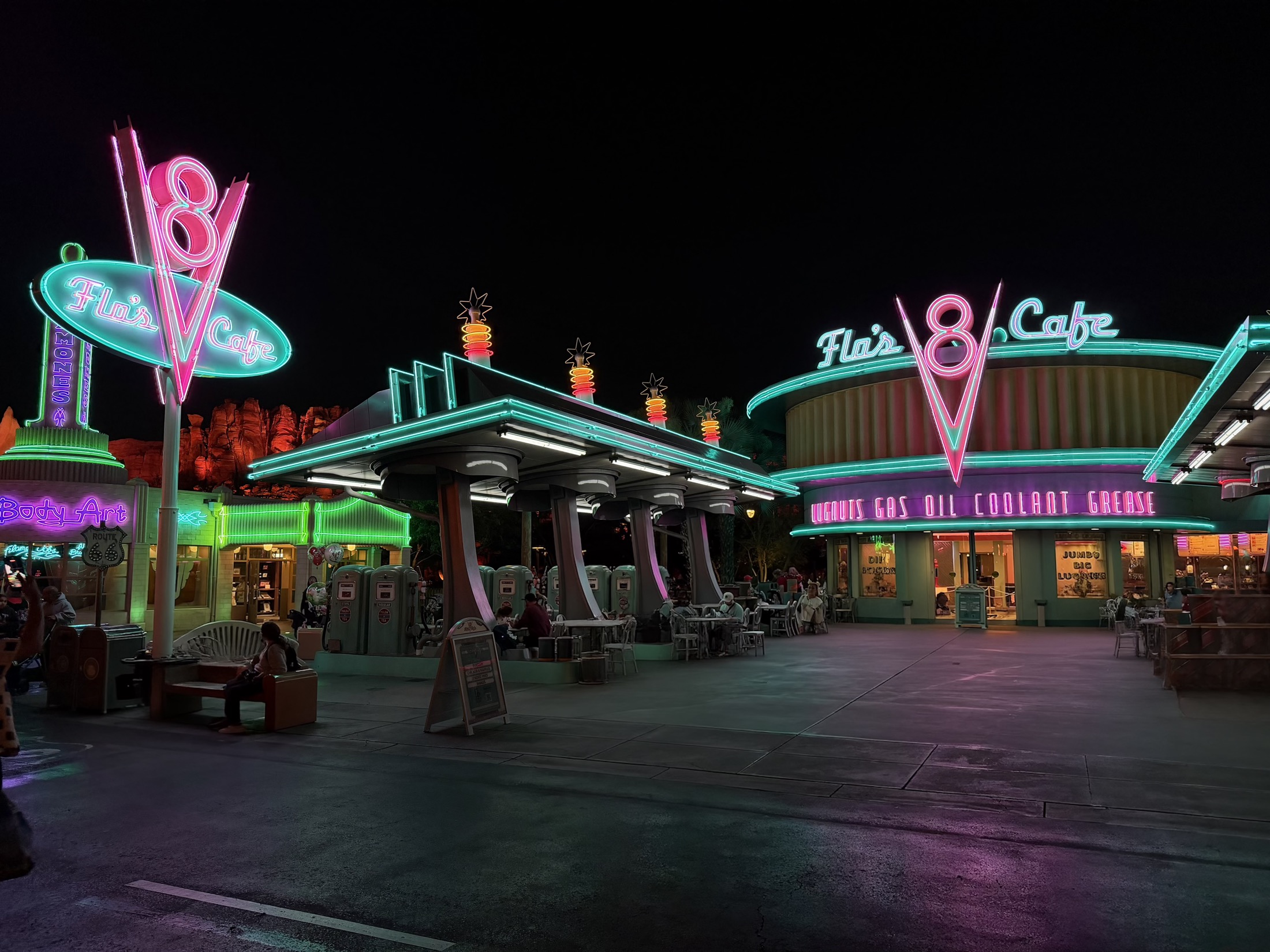Flo's V8 Cafe lit up with neon lights at night